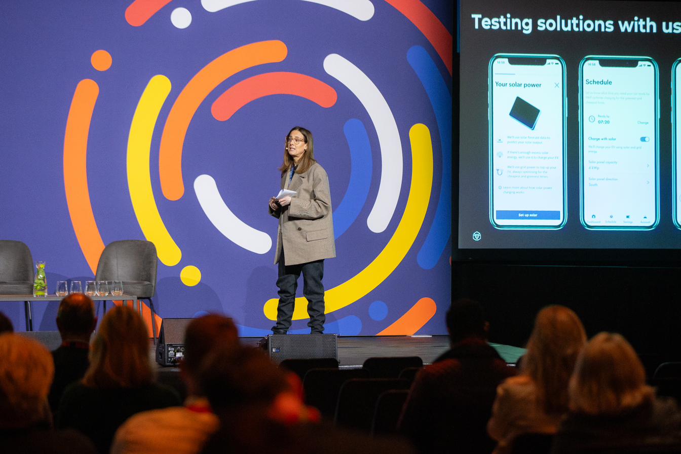 Evi presenting a keynote on stage