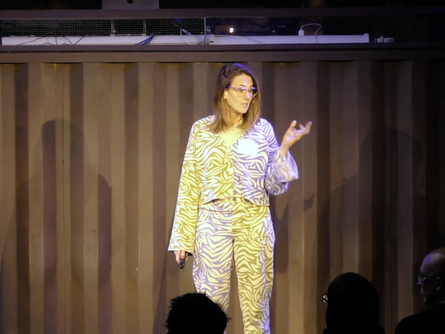 Evi presenting solo on stage at the Kaluza offsite